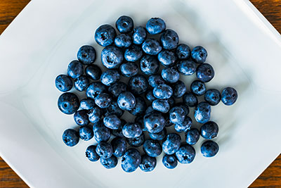 Just Some Blueberries On A Plate On A Table